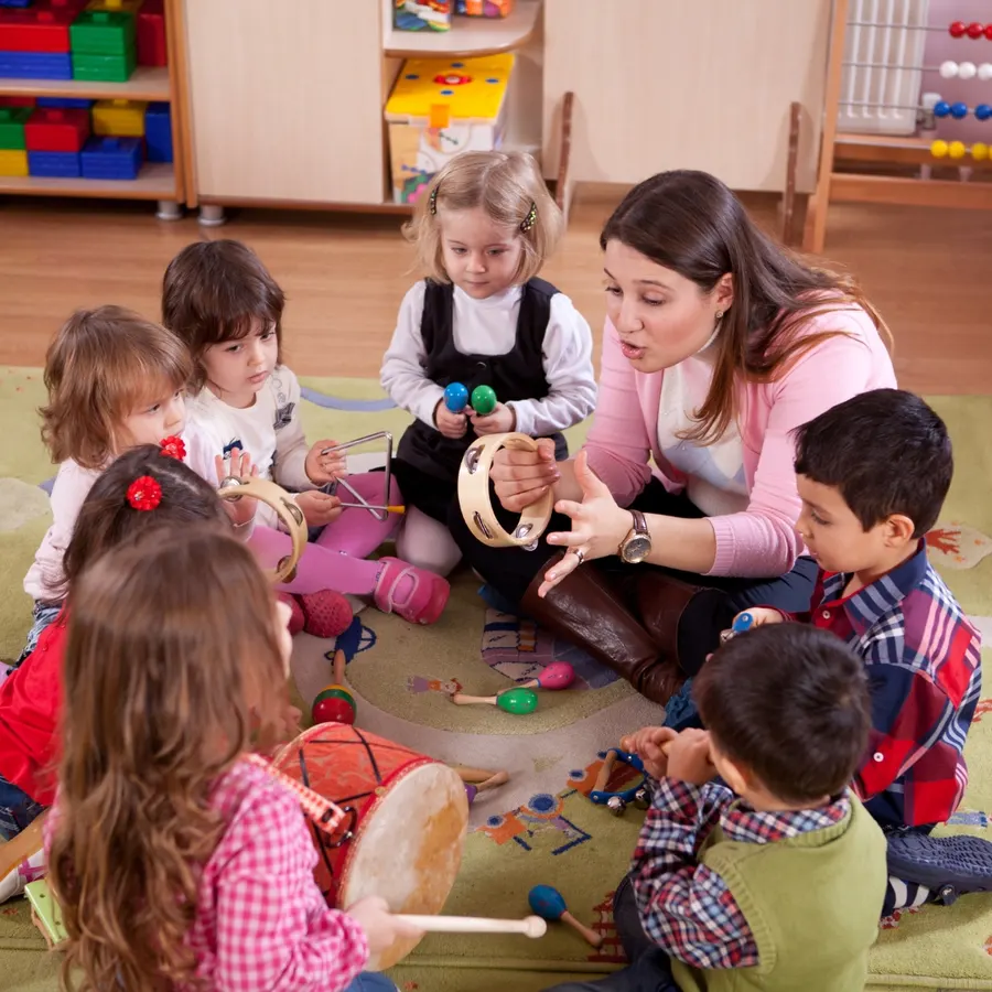 An adult mentoring children during a craft activity