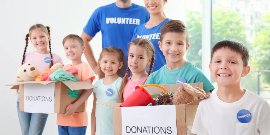 Children carrying donation bags at a community event