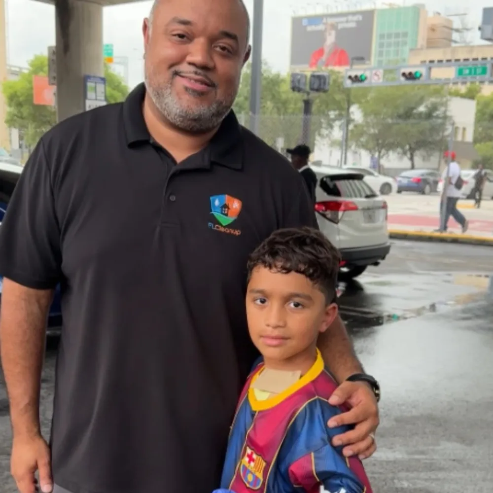 James Rice-Peña with a child at a community event