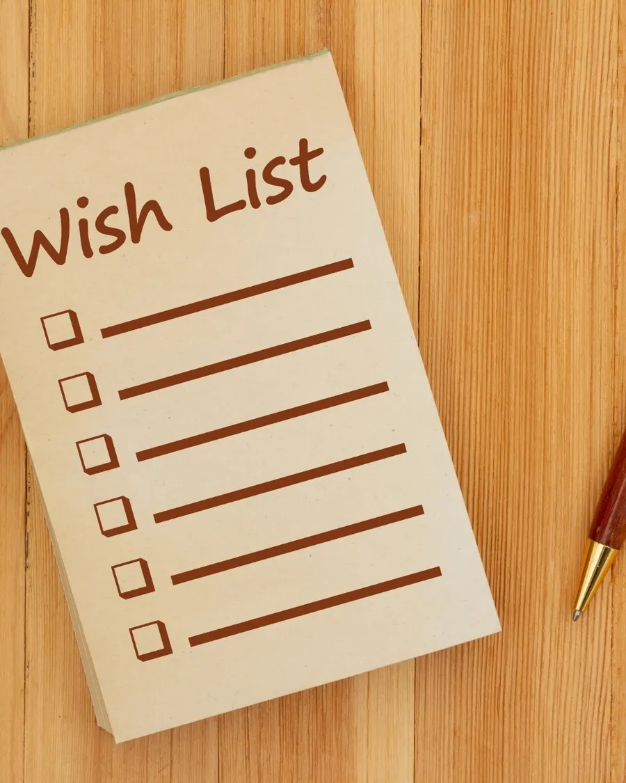 A handwritten wish list on a notepad